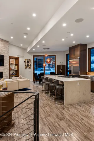 a living room with stainless steel appliances kitchen island granite countertop furniture and a kitchen view
