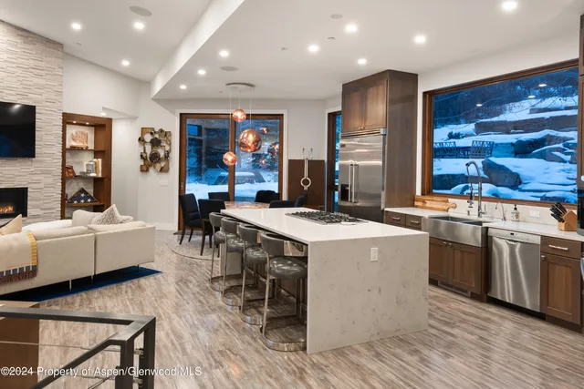 a kitchen with stainless steel appliances granite countertop a stove and a refrigerator