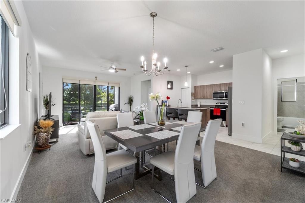 4925 Gambero Way Avenue Immokalee, FL 34142 - Photo 13 of 50 a dining room with furniture a chandelier and window