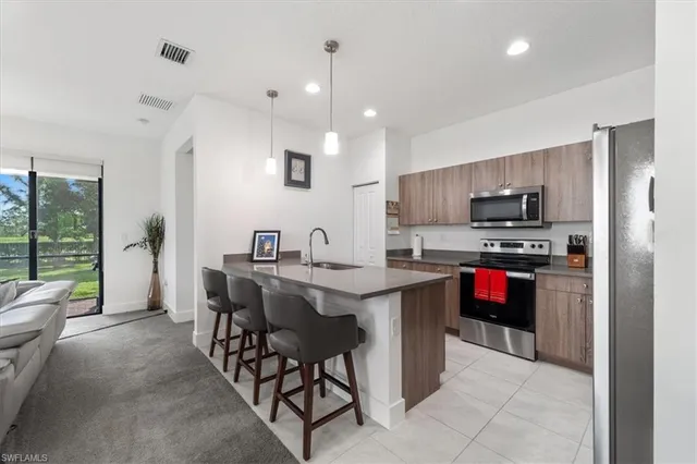 a kitchen with kitchen island granite countertop a sink and a stove