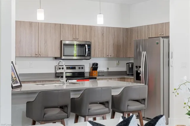 a kitchen with a sink cabinets and appliances