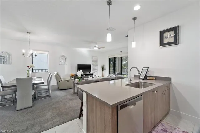 a view of kitchen island a sink a table and chairs