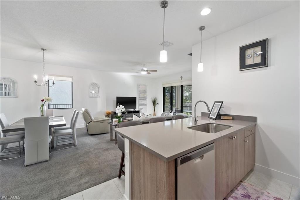 4925 Gambero Way Avenue Immokalee, FL 34142 - Photo 18 of 50 a view of kitchen island a sink a table and chairs