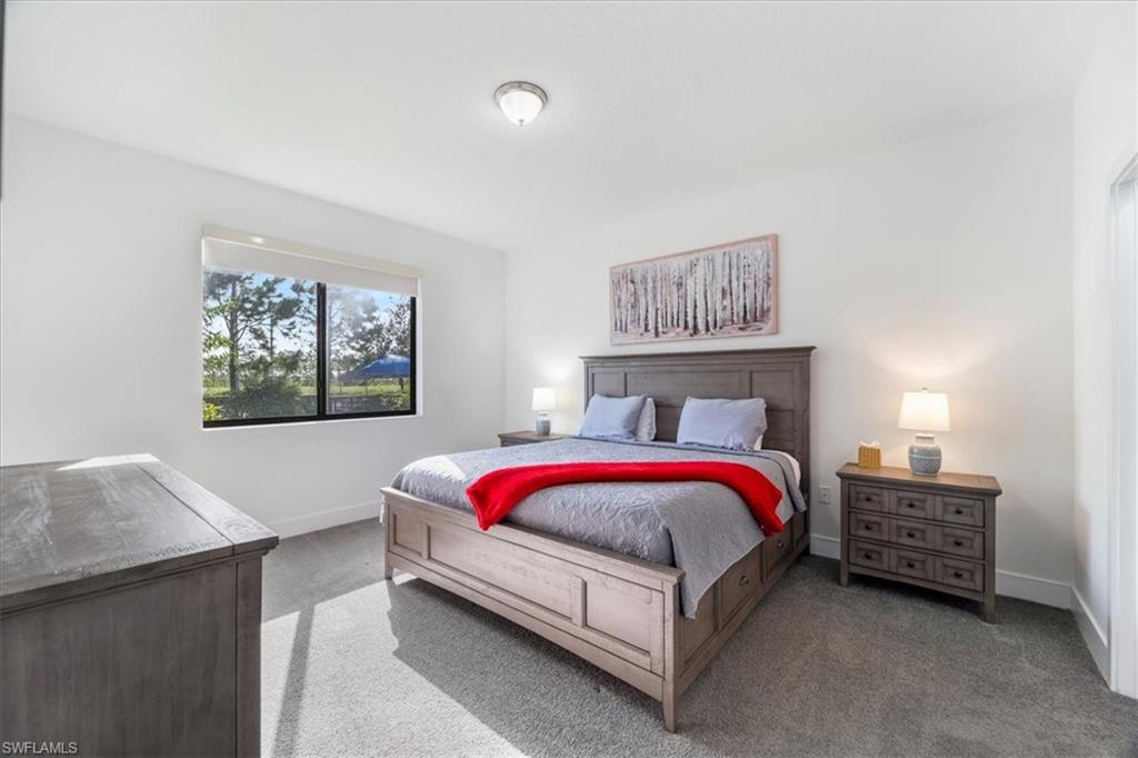 4925 Gambero Way Avenue Immokalee, FL 34142 - Photo 19 of 50 a spacious bedroom with a bed and a couch