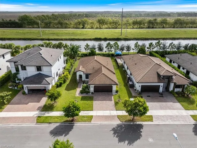 an aerial view of a house with a garden and lake view