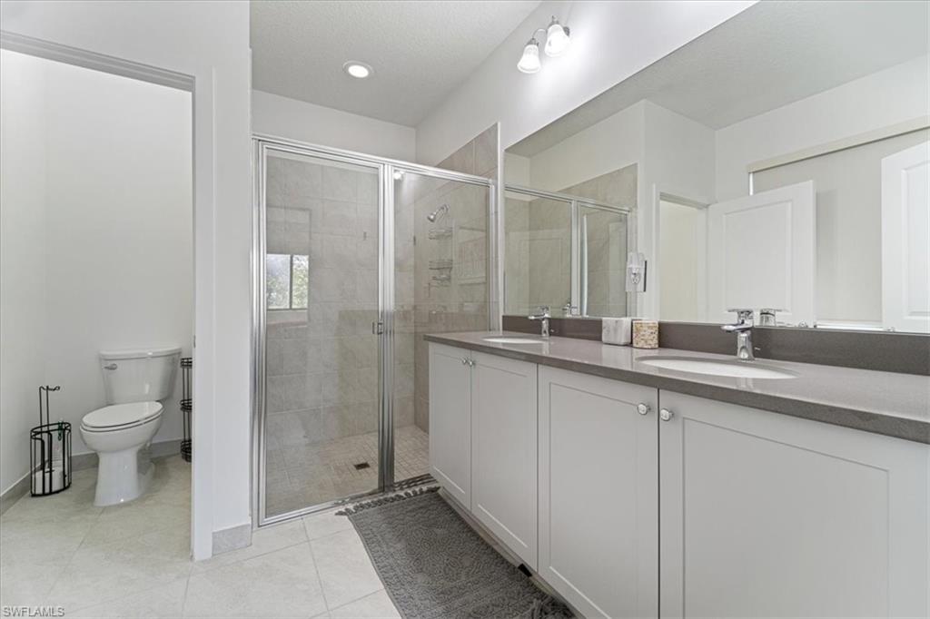 4925 Gambero Way Avenue Immokalee, FL 34142 - Photo 22 of 50 a bathroom with a double vanity sink mirror and toilet