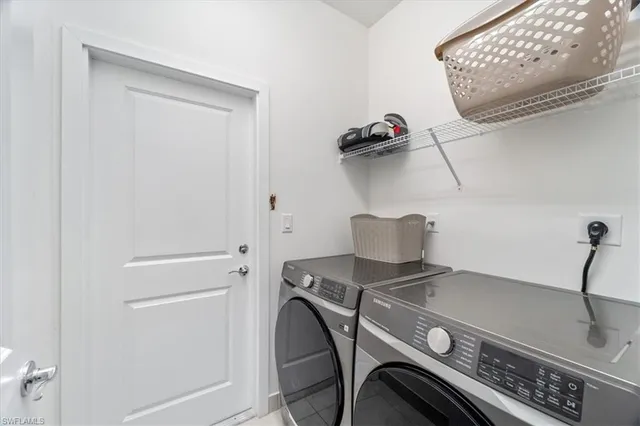 a view of storage and utility room with washer and dryer