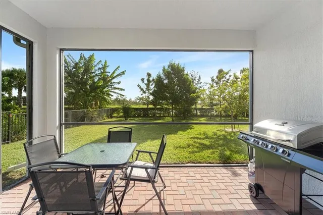 a balcony with table and chairs
