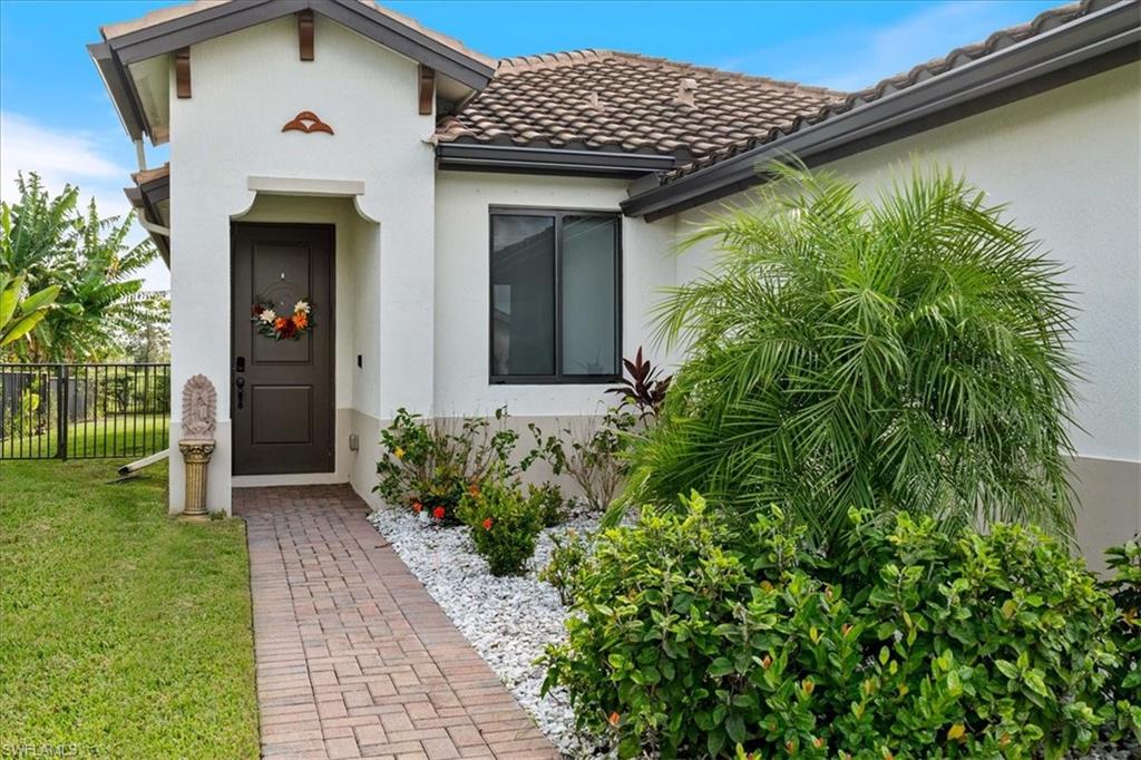 4925 Gambero Way Avenue Immokalee, FL 34142 - Photo 5 of 50 a front view of a house with garden