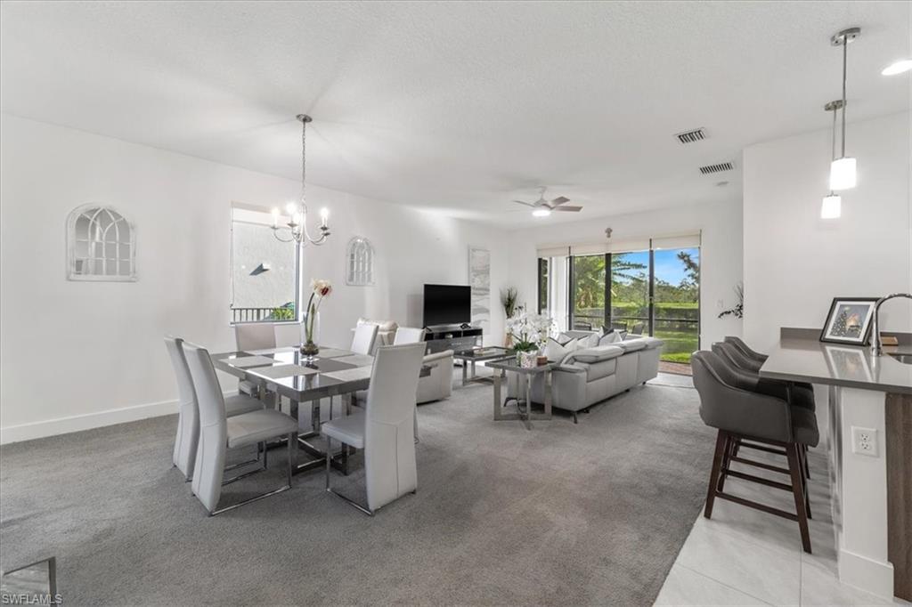 4925 Gambero Way Avenue Immokalee, FL 34142 - Photo 7 of 50 a living room with furniture and a chandelier