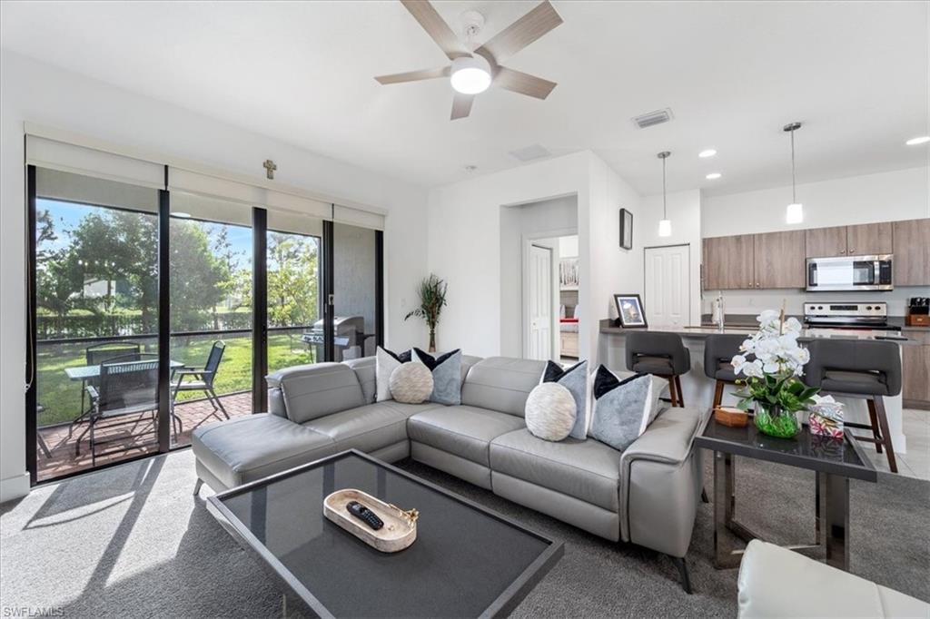 4925 Gambero Way Avenue Immokalee, FL 34142 - Photo 9 of 50 a living room with furniture and a large window with kitchen view