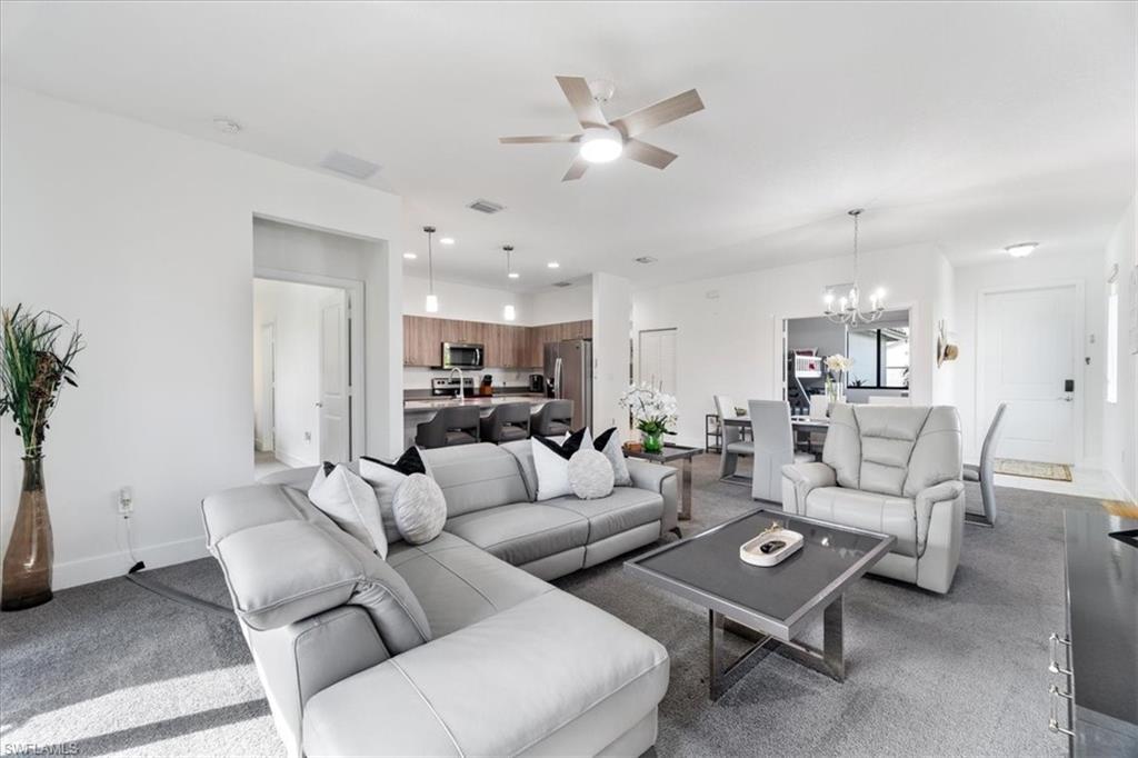 4925 Gambero Way Avenue Immokalee, FL 34142 - Photo 10 of 50 a living room with furniture kitchen view and a chandelier
