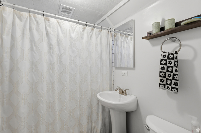 85 North 800 West Provo, UT 84601 - Photo 21 of 25 Bathroom featuring a pedestal sink, wall-mounted mirror, and a shower area with a curtain rod