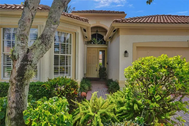 a kitchen with stainless steel appliances granite countertop a table chairs refrigerator and sink