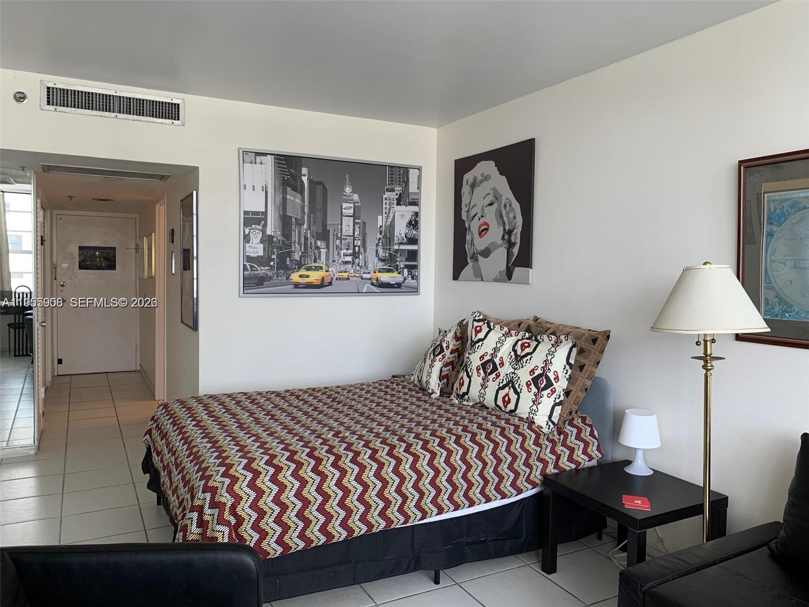 100 Lincoln Road, Unit 903 Miami Beach, FL 33139 - Photo 5 of 17 a bedroom with a bed and window