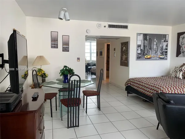 a living room with furniture a flat screen tv and a window