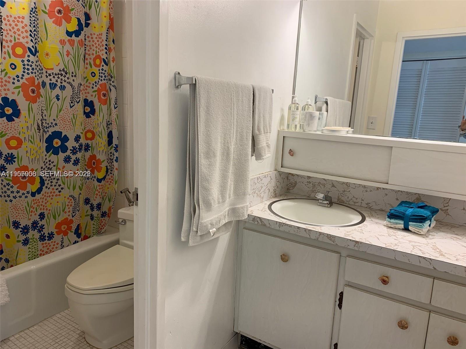 100 Lincoln Road, Unit 903 Miami Beach, FL 33139 - Photo 9 of 17 a bathroom with a granite countertop sink and a mirror