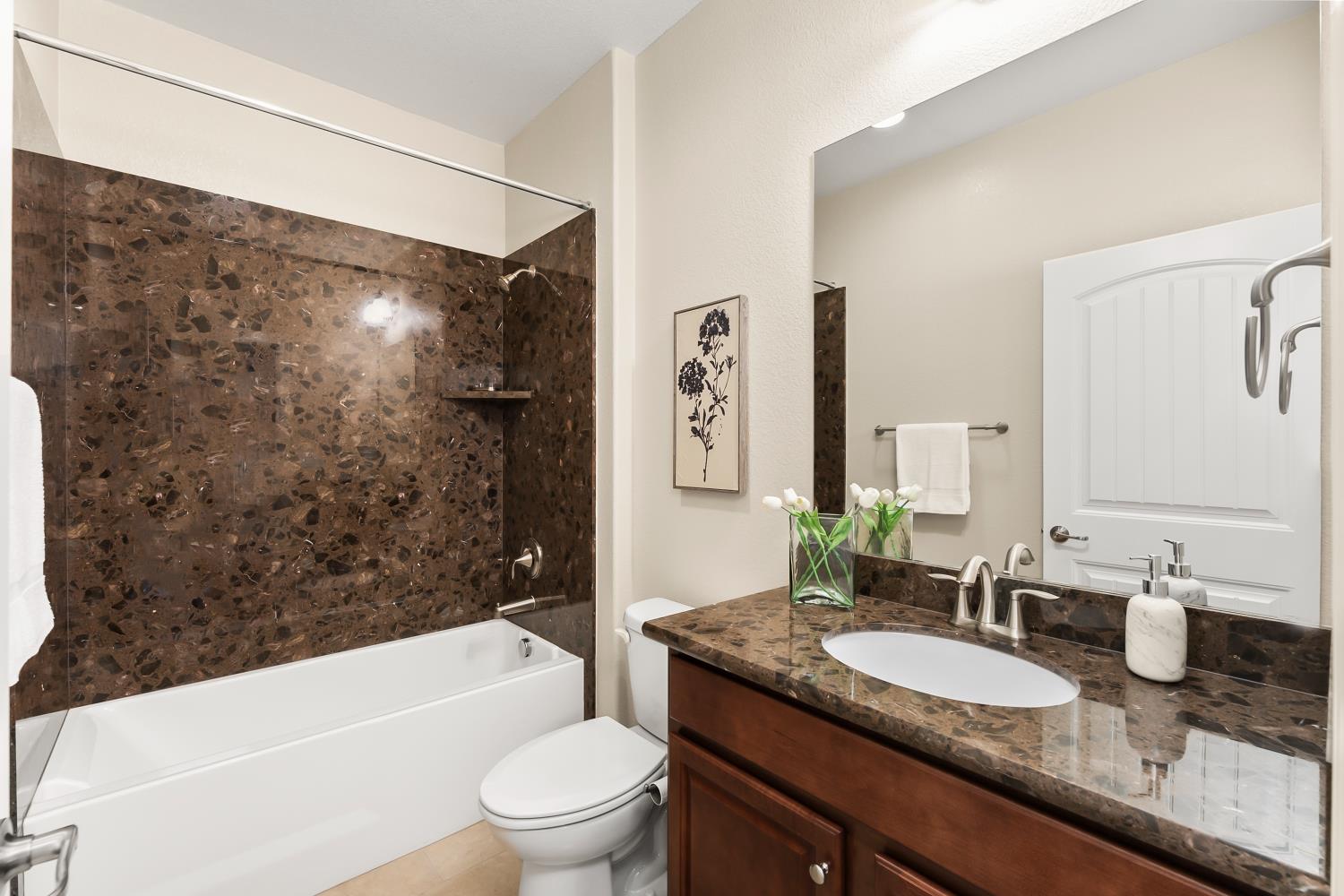 5453 Mossy Stone Way Rancho Cordova, CA 95742 - Photo 13 of 81 a bathroom with a granite countertop sink toilet and shower