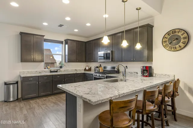 a kitchen with a table chairs sink and cabinets