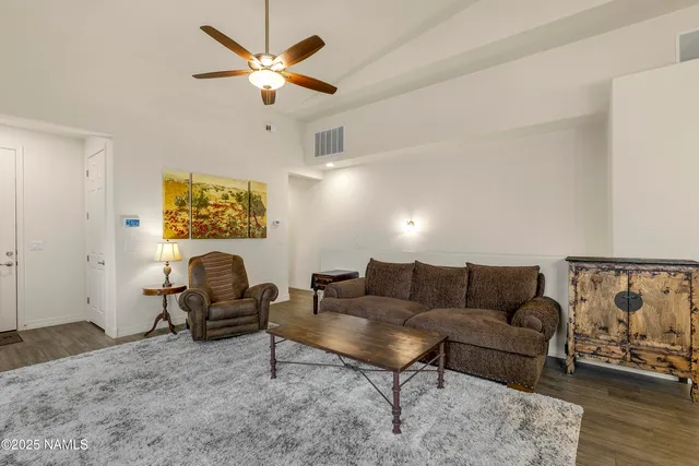 a living room with furniture and a ceiling fan