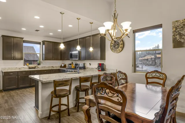 a large kitchen with a table and chairs
