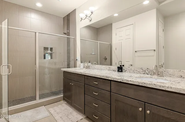 a bathroom with a granite countertop sink mirror and double