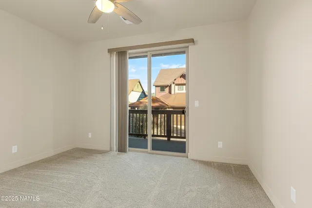 an empty room with windows and chandelier