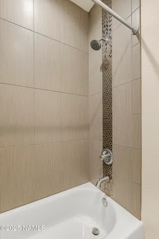 a bathroom with a sink a shower and a tub