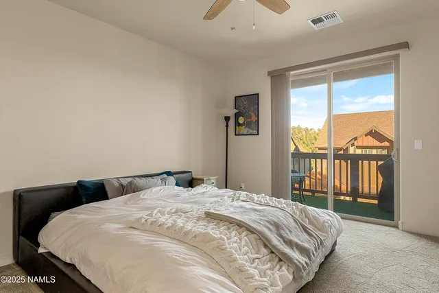 a bedroom with a large bed and a large window