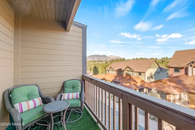 a view of a chairs and table in the balcony