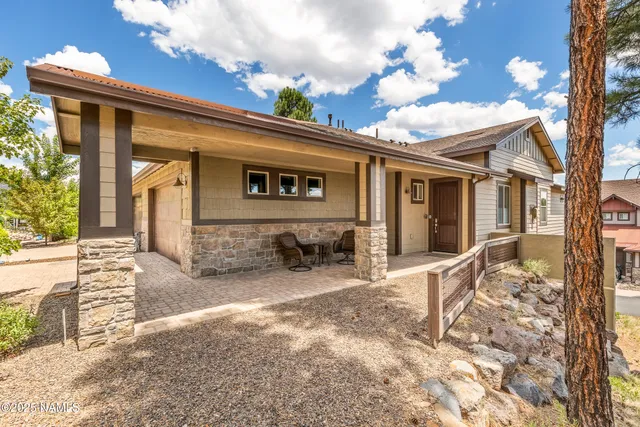 a backyard of a house with yard and outdoor seating