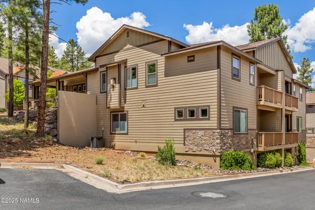 a view of a house with a yard and garage