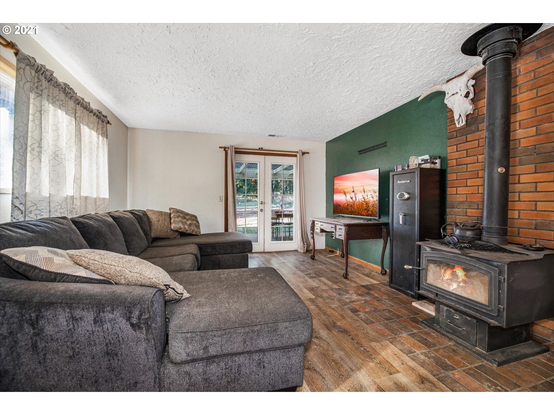 17707 Southeast Amisigger Road Boring, OR 97009 - Photo 5 of 23 a living room with furniture a flat screen tv and a window