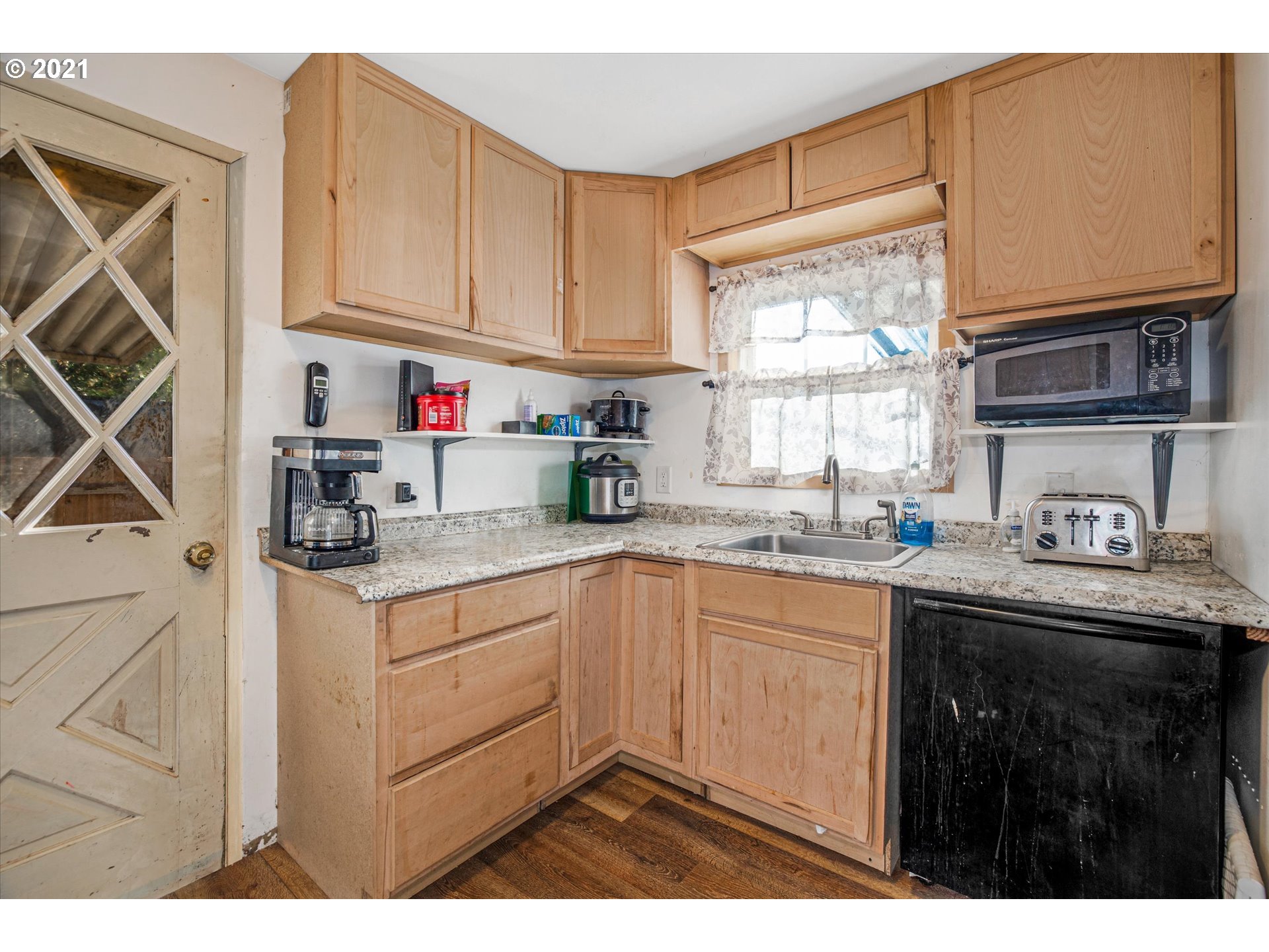 17707 Southeast Amisigger Road Boring, OR 97009 - Photo 9 of 23 a kitchen with kitchen island granite countertop a sink window and cabinets