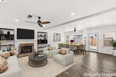 a living room with furniture a fireplace and a flat screen tv