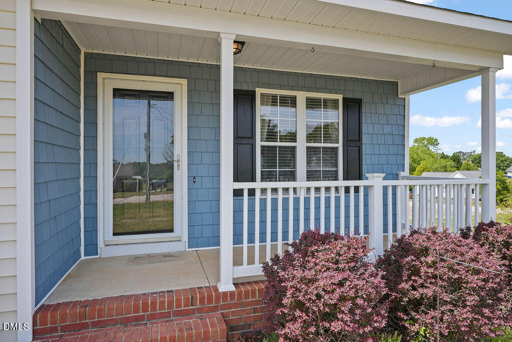 1560 Cane Mill Road Coats, NC 27521 - Photo 5 of 32 a view of a house with a small yard and wooden floor and fence