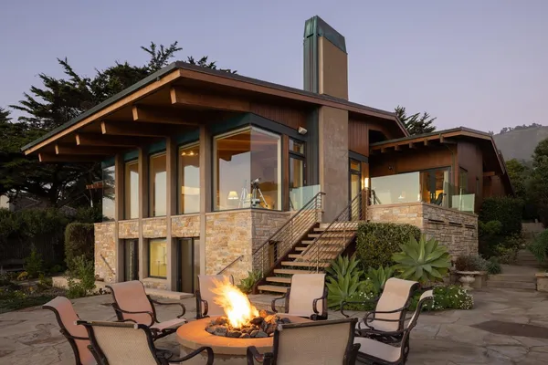a view of a house with backyard and a patio