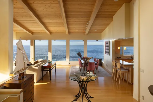 a living room with furniture and large windows