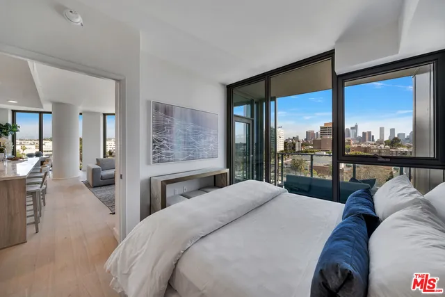 a bedroom with a large bed and a balcony