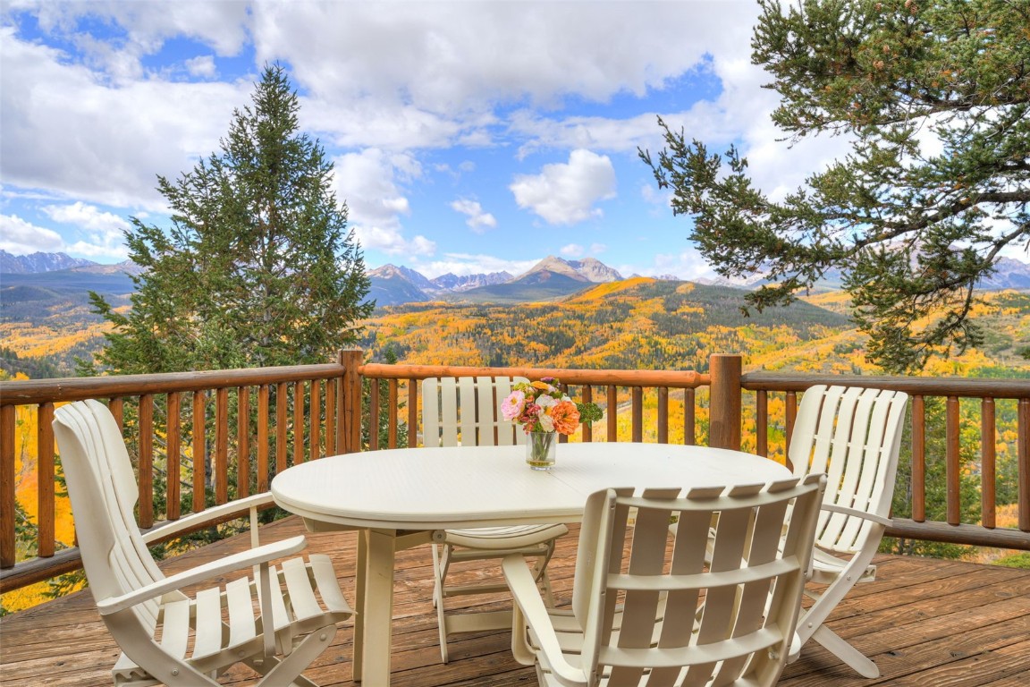 a view of a balcony with mountain view and wooden floor