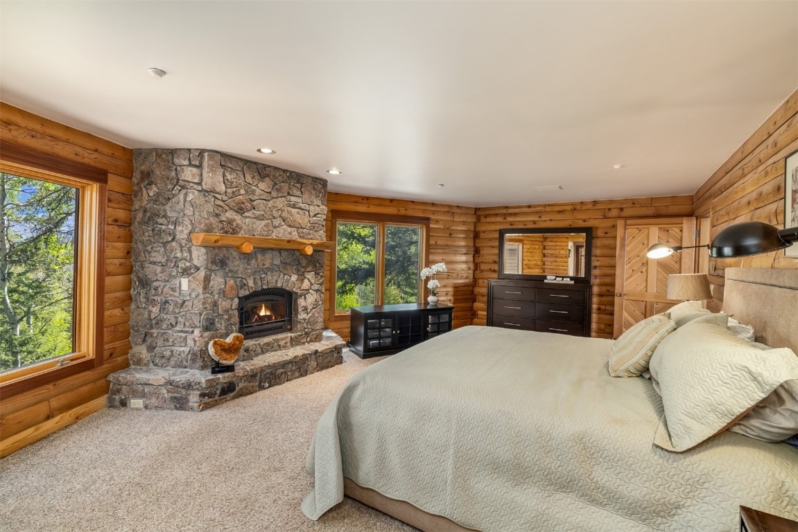 2244 Johnson Road Silverthorne, CO 80498 - Photo 19 of 45 a bedroom with a bed and a fireplace