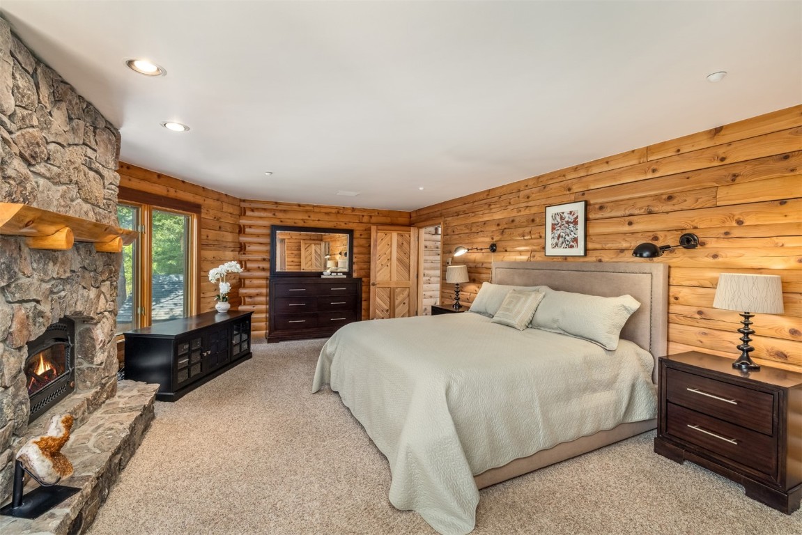2244 Johnson Road Silverthorne, CO 80498 - Photo 20 of 45 a spacious bedroom with a bed a dresser with wooden floor