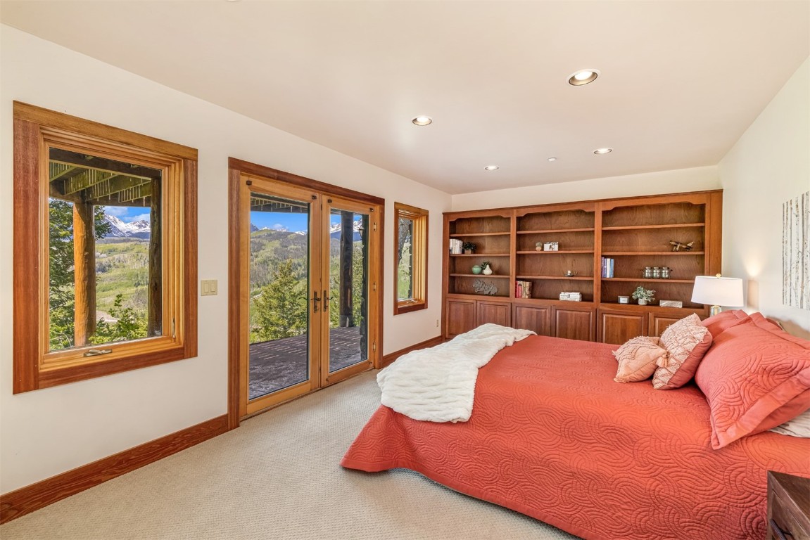 2244 Johnson Road Silverthorne, CO 80498 - Photo 33 of 45 a large bedroom with a large bed and large windows
