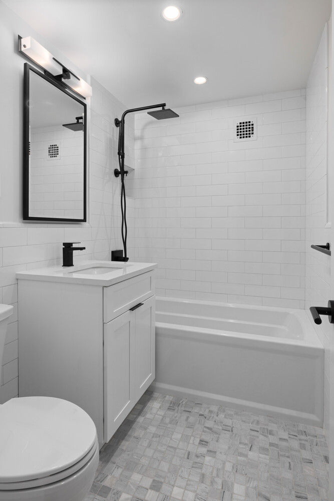 11 Riverside Drive, Unit 15HW Manhattan, NY 10023 - Photo 13 of 14 a bathroom with a toilet sink and mirror