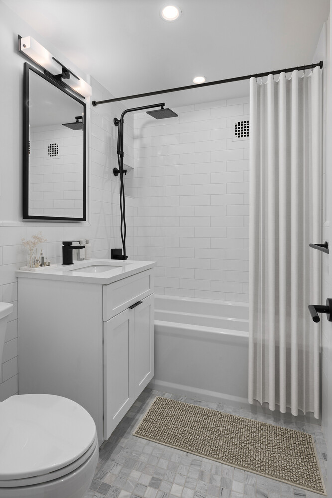 11 Riverside Drive, Unit 15HW Manhattan, NY 10023 - Photo 8 of 14 a bathroom with a shower a sink and a mirror