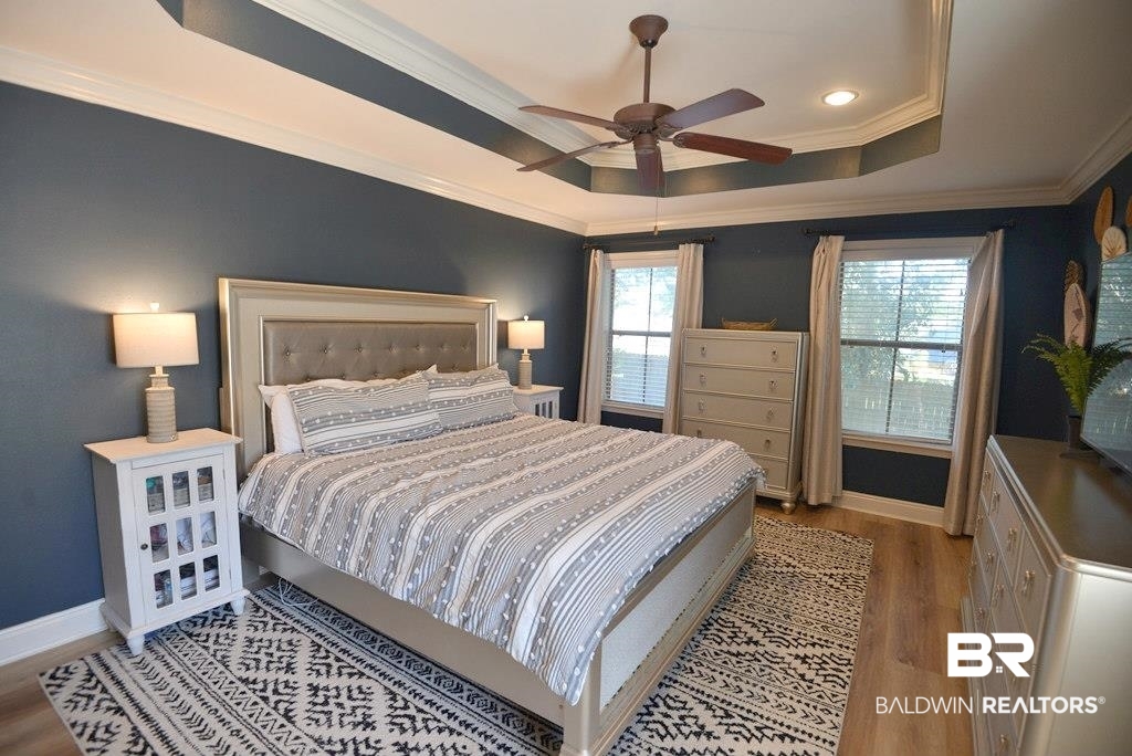 11201 Herschel Loop Daphne, AL 36526 - Photo 23 of 32 Bedroom with multiple windows, wood-type flooring, crown molding, and ceiling fan