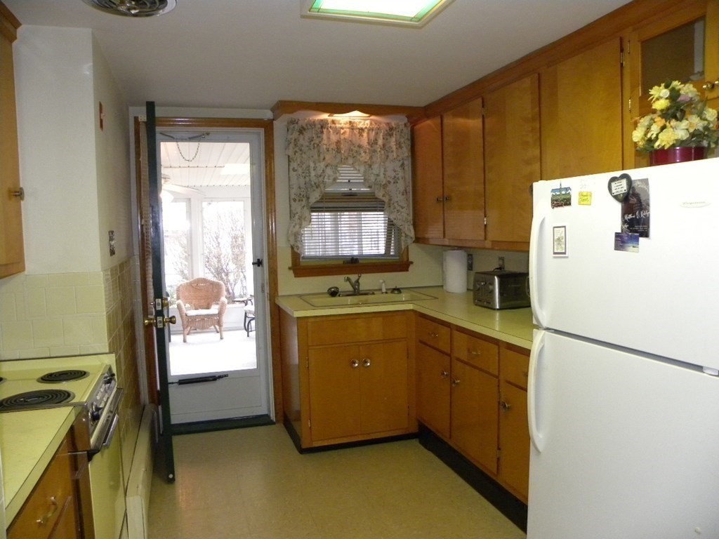 8 Everett Avenue Webster, MA 01570 - Photo 12 of 29 a kitchen with a refrigerator and a stove