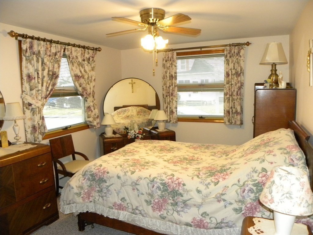 8 Everett Avenue Webster, MA 01570 - Photo 13 of 29 a bedroom with a bed and a chandelier