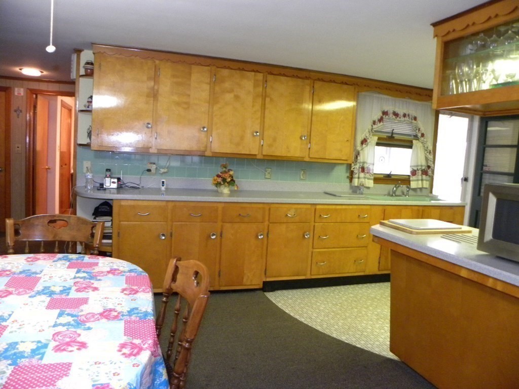 8 Everett Avenue Webster, MA 01570 - Photo 16 of 29 a kitchen with a sink stove and mirror