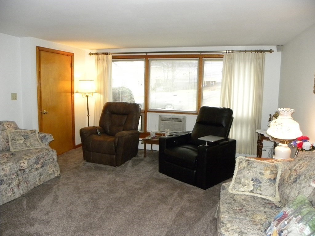 8 Everett Avenue Webster, MA 01570 - Photo 17 of 29 a living room with furniture and a floor to ceiling window